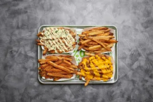 A variety of crispy fries on a tray, perfect for sharing with your burger.
