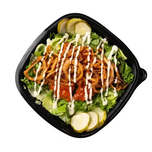 Crispy onion and BBQ chicken salad with pickles and ranch drizzle.