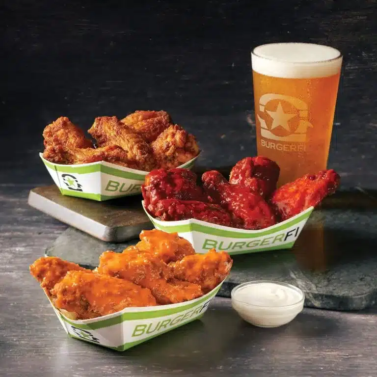  BurgerFi beer along with various chicken wings and dip. 